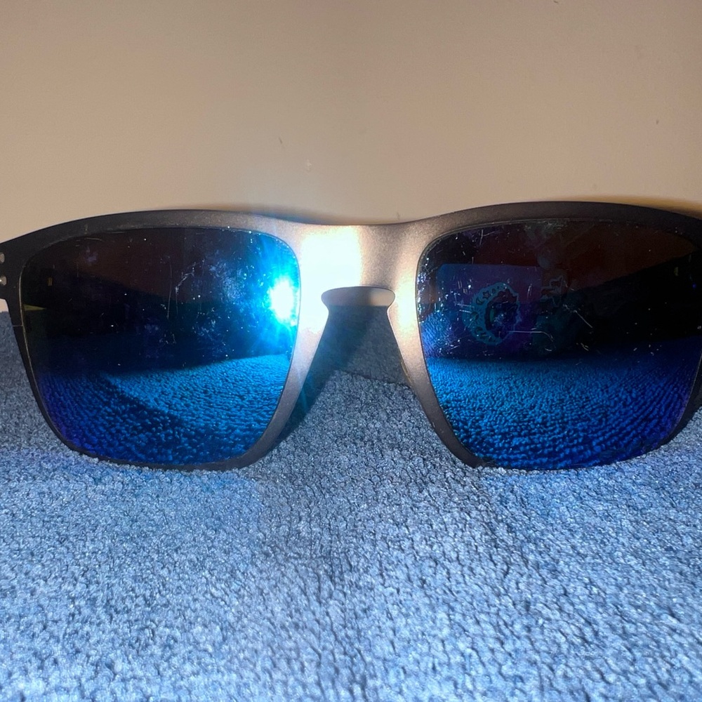 Oakley Sunglasses with Black Frame and Blue Logo see photos